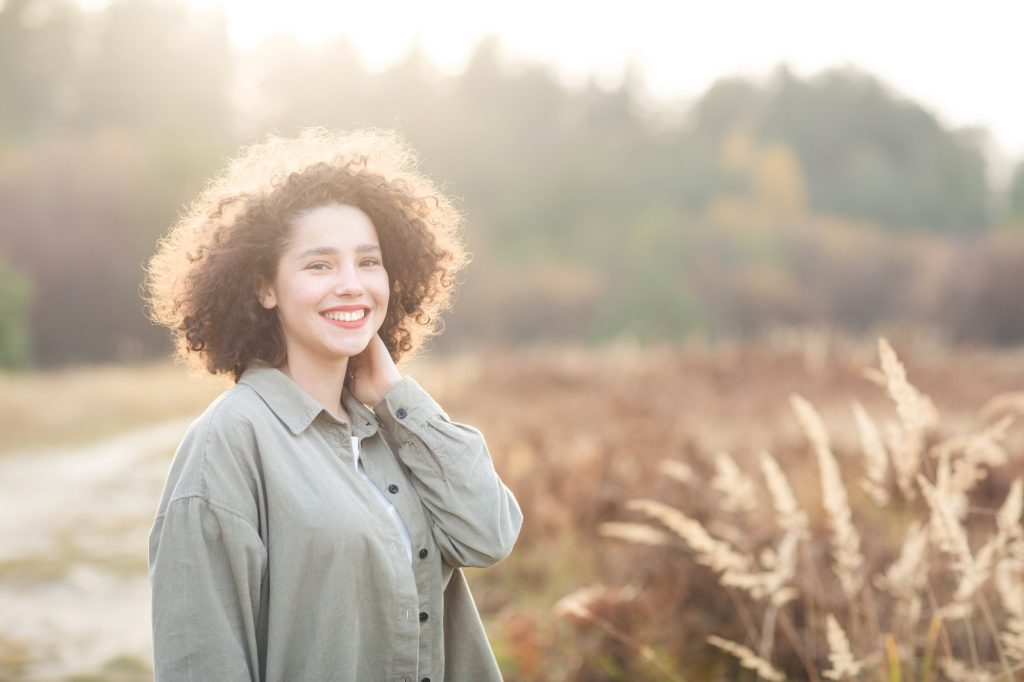 portrait of young pretty mixed race teen girl outdoor in sunlight.